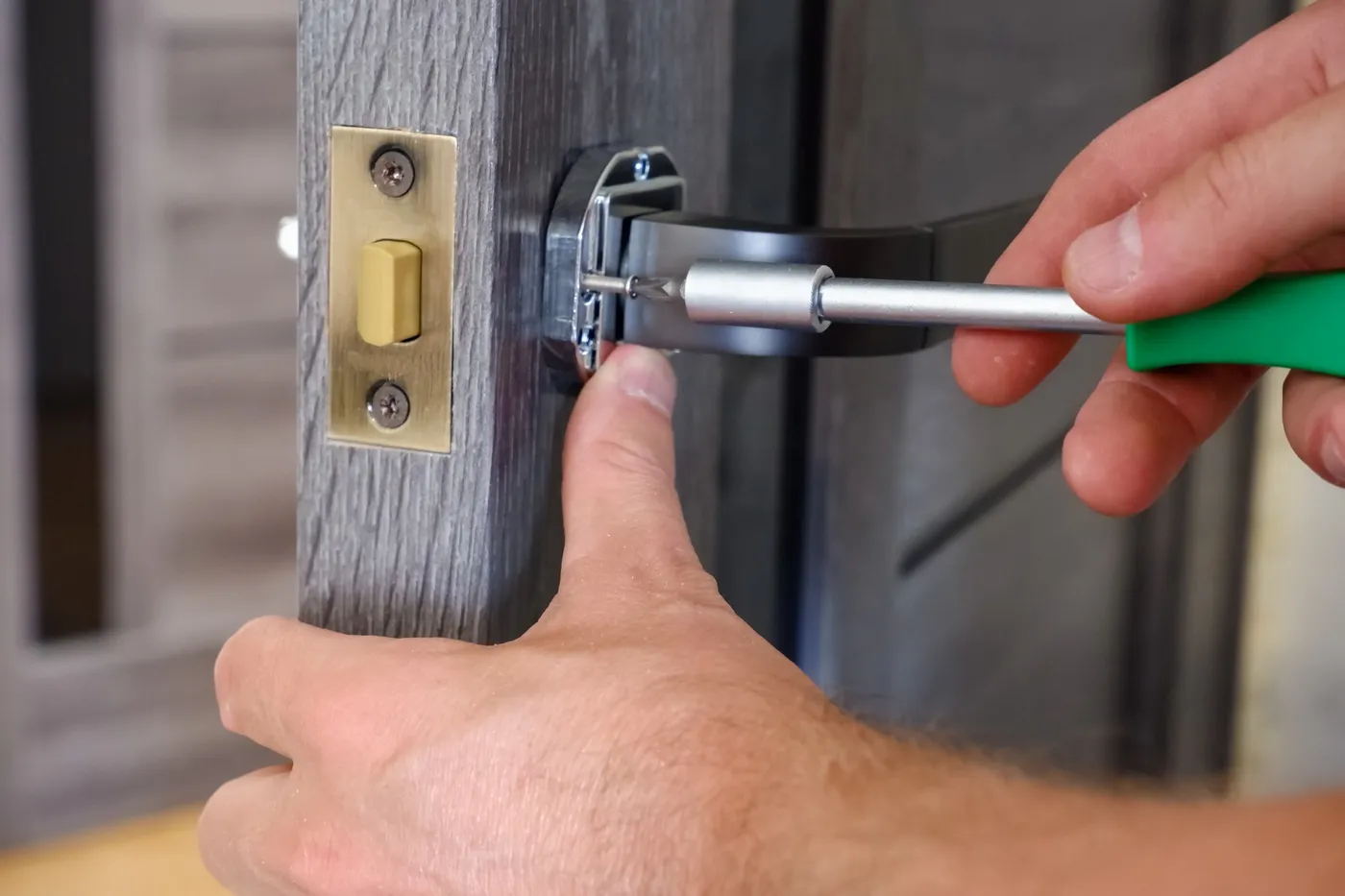 Handyman adjusting a timber door in a London residential interior